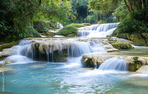 Waterfall cascading down rocks, natural beauty, ecotourism spring destination, funded ecotourism project. 