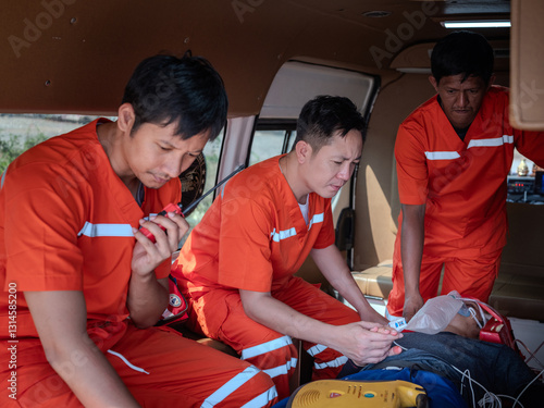 Obraz na płótnie Emergency medical team working together to provide urgent care and transport a patient in the back of an ambulance, delivering lifesaving medical treatment and assistance during a critical situation. w salonie