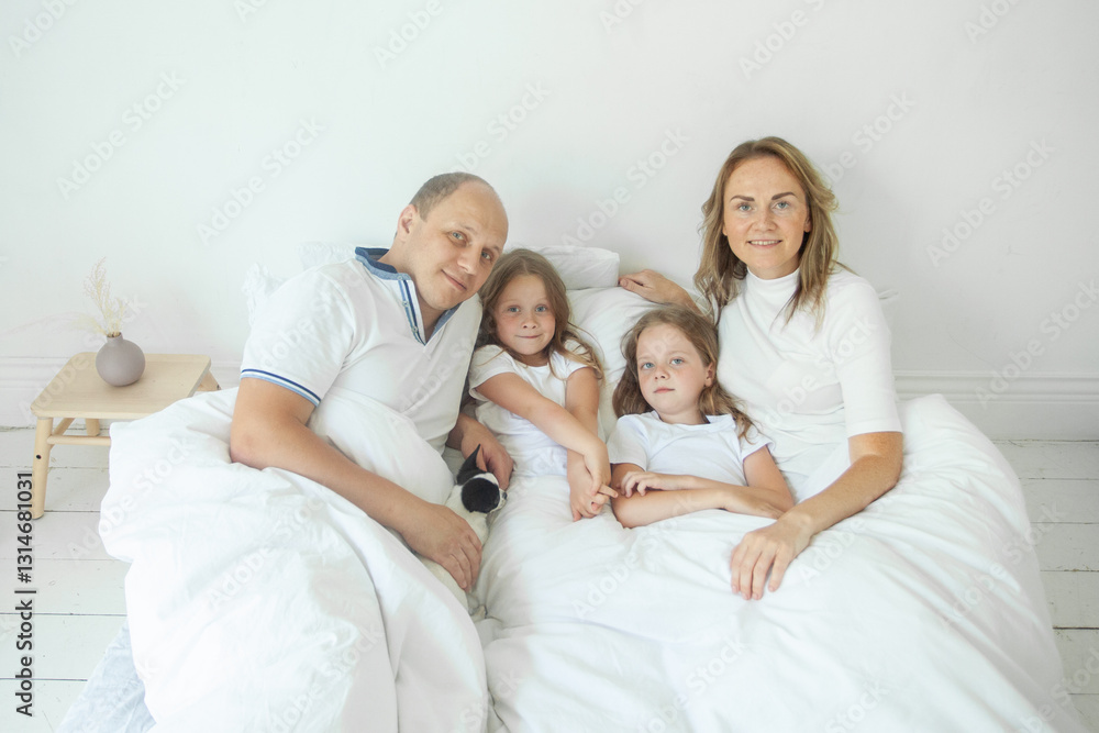Cute mother, father and girls at home. Happy family Cute mother, father and girls at home. Happy family