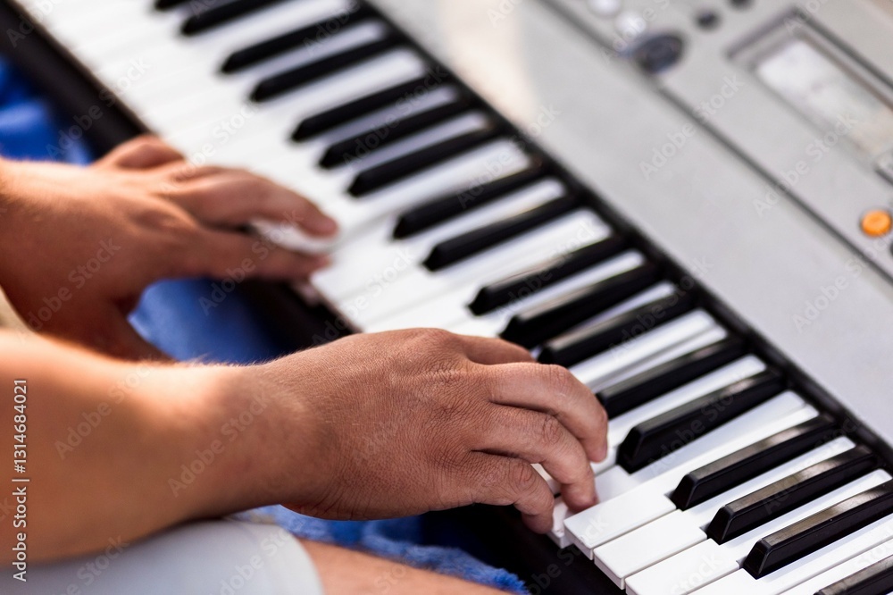 Close-up of male playing electronic keyboard with skilled hands outdoors Close-up of male playing electronic keyboard with skilled hands outdoors