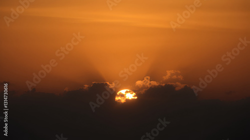 Wallpaper Mural Serene sunset with clouds partially obscuring the golden sun Torontodigital.ca