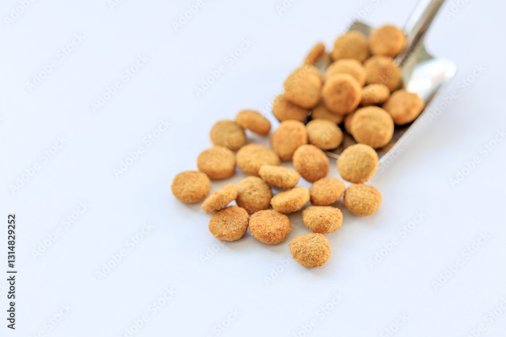 A spoonful of dog food is shown on a white background A spoonful of dog food is shown on a white background