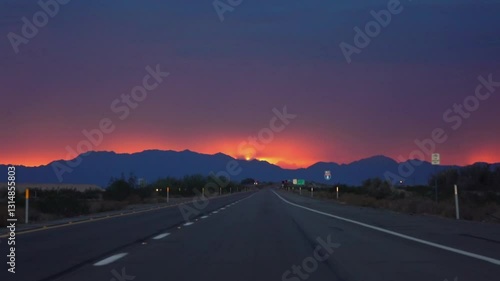 Driving on a road to Yuma, Arizona with a vibrant sunset in slow motion 120fps