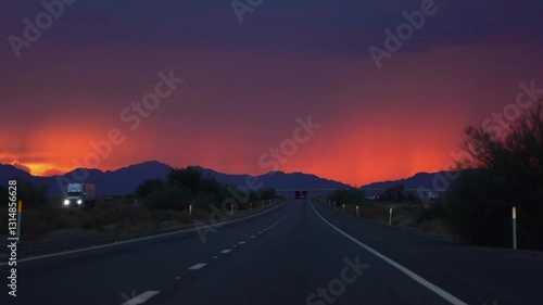 Driving on a road to Yuma, Arizona with a vibrant sunset in slow motion 120fps
