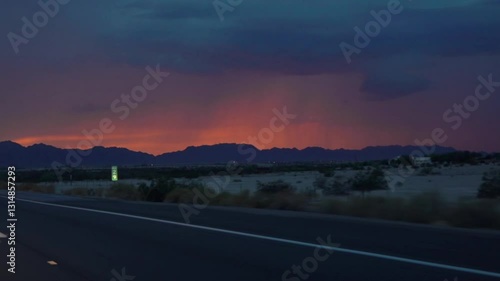 Driving on a road to Yuma, Arizona with a vibrant sunset in slow motion 120fps