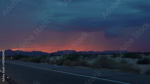 Driving on a road to Yuma, Arizona with a vibrant sunset in slow motion 120fps