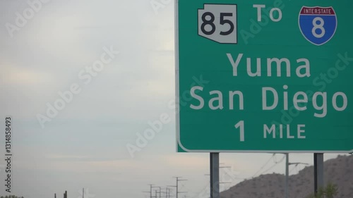 Driving on a highway in Arizona with road signs for Yuma and San Diego in slow motion 120fps