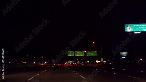 Driving at night on the road to Yuma, Arizona with illuminated road signs in slow motion 120fps