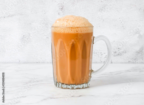 Photography Teh Tarik Malaysian hot milk tea served in Glass Mug isolated on marble backgrou