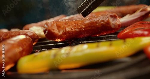 Ultra slow-motion shot of meet sausages getting cooked on the barbeque grill. Close-up footage