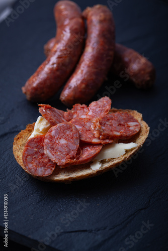 Sliced chorizo on toasted bread.