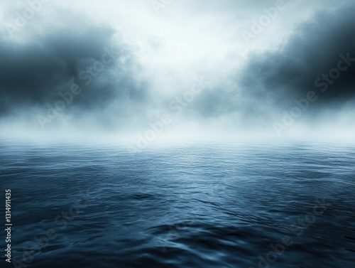 Serene expanse of dark blue ocean waters under a misty sky with dramatic clouds creating a moody and atmospheric seascape for stock photography