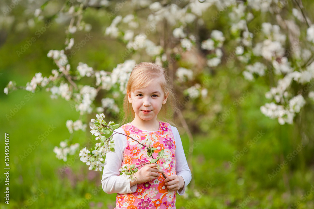 Little blonde girl admiring a blooming apple tree branch in a spring garden Little blonde girl admiring a blooming apple tree branch in a spring garden