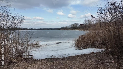 Wallpaper Mural slow motion video winter landscape on frozen lake. cracked ice on river. Bird watching in the wild. Slow motion video in 4k. Hand held video of lake shore frost winter cold wether Torontodigital.ca