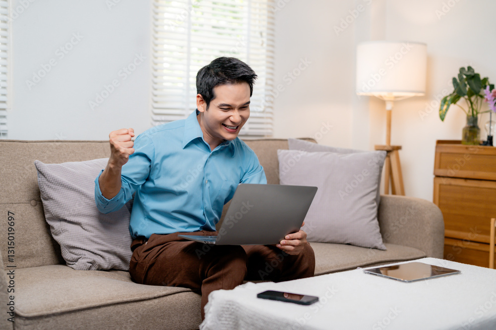 Cheerful Asian freelancer rejoicing over successful project, working on laptop in cozy home workspace with emotional expression Cheerful Asian freelancer rejoicing over successful project, working on laptop in cozy home workspace with emotional expression