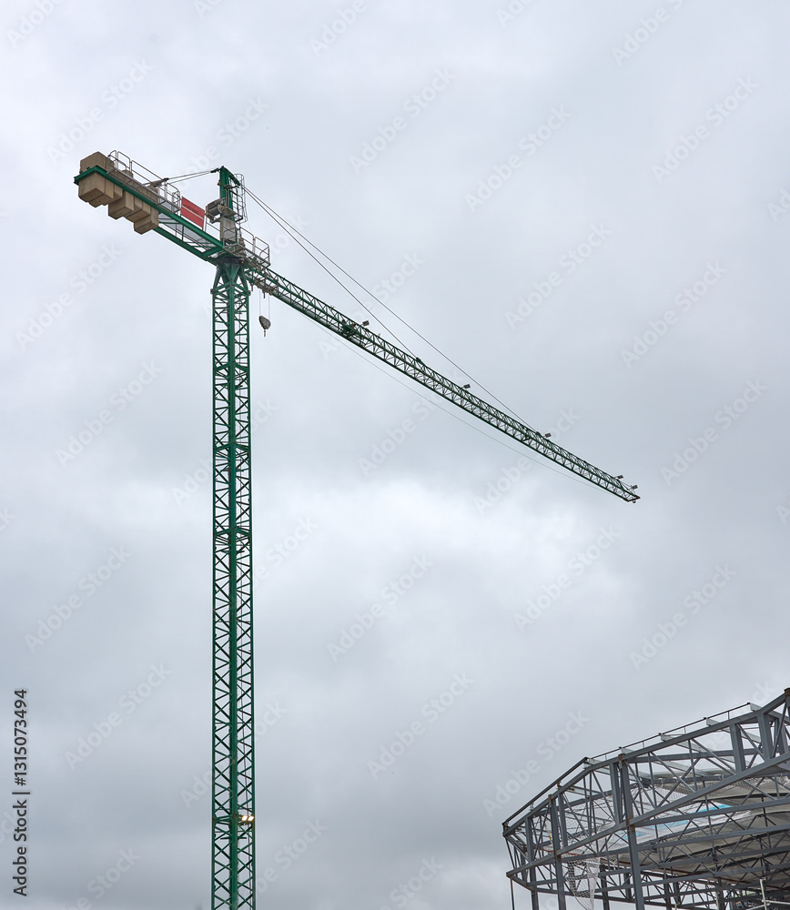 Construction site crane over building carcass Construction site crane over building carcass