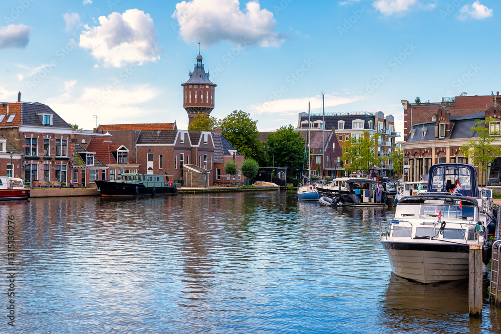 Φωτογραφία Scenic canal with historic buildings and boats in Sneek, Netherlands