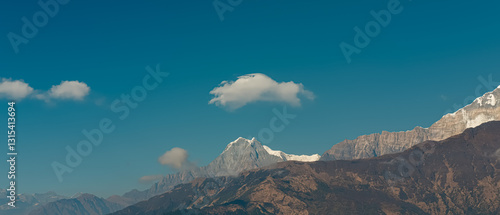 GHOREPANI, NEPAL - JANUARY 9, 2025: Stunning evening view of the Annapurna mountain range from Ghorepani village, ultra-wide.