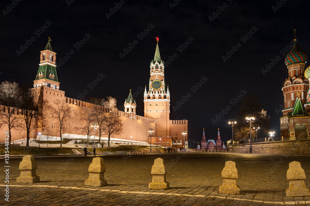 Moscow, Russia. Evening view from Vasilyevsky Spusk to the Moscow Kremlin. Spasskaya Tower against the dark sky. Sights of Moscow.