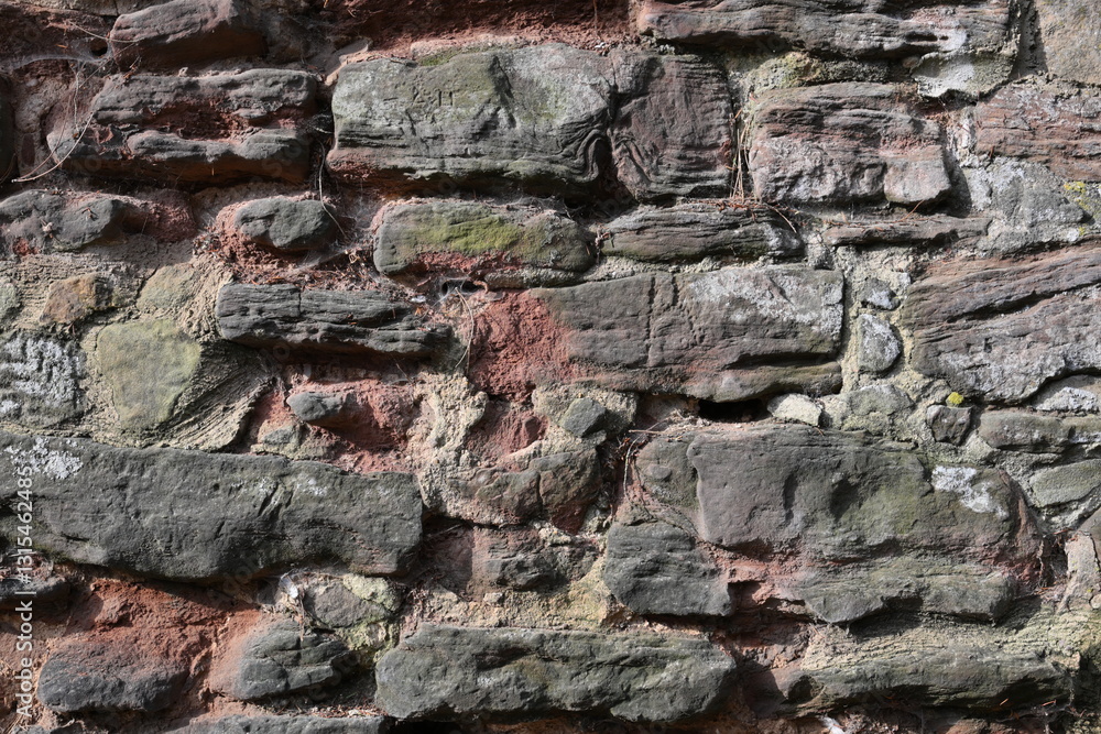 Fototapeta premium A wall made of stone with a red spot on it