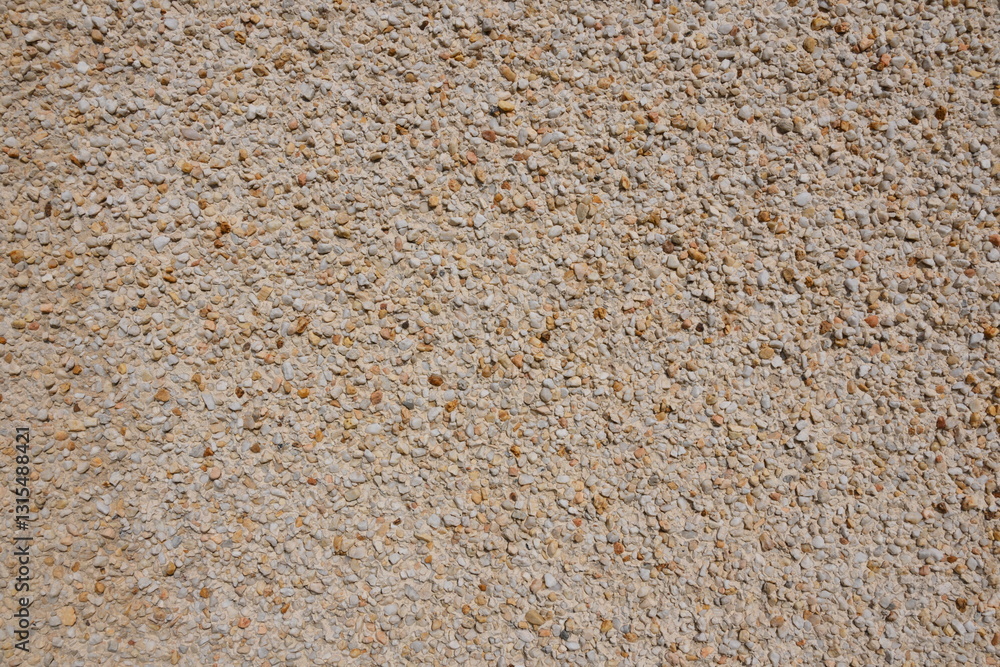 A wall with a lot of small rocks on it A wall with a lot of small rocks on it