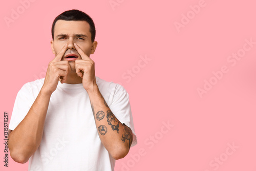 Ill young man on pink backg...