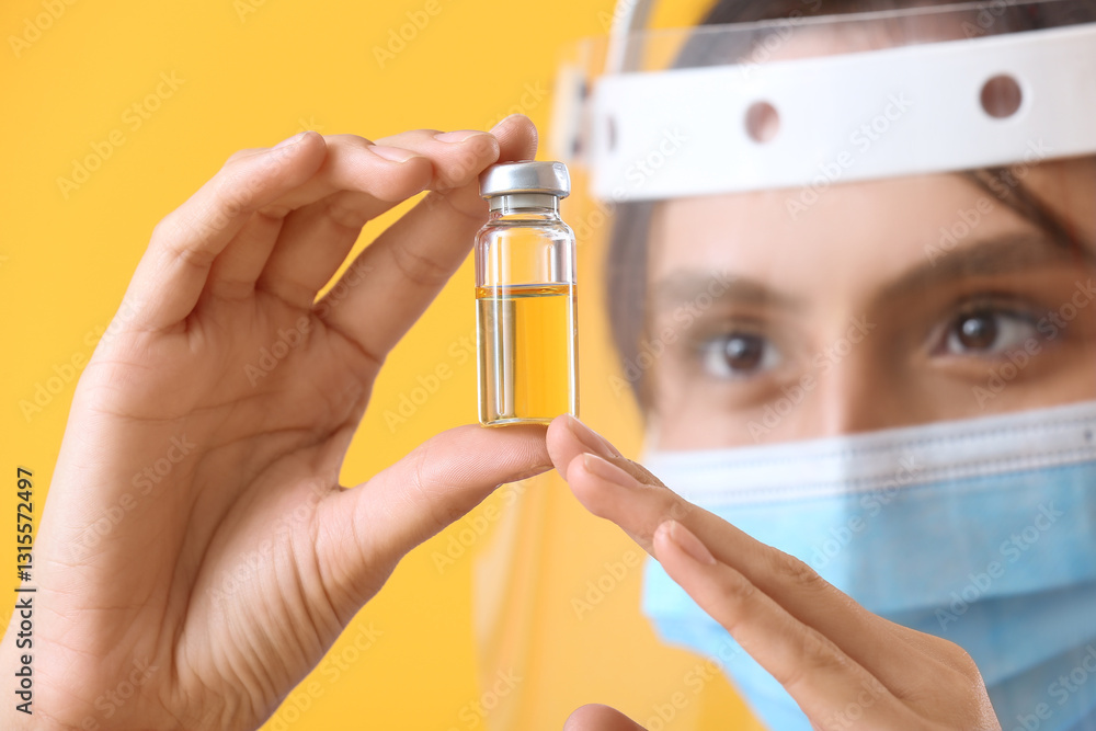 Fototapeta premium Female doctor in protective masks with ampule on yellow background, closeup