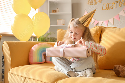Cute little girl sitting on...