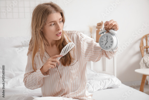 Shocked young woman holding...