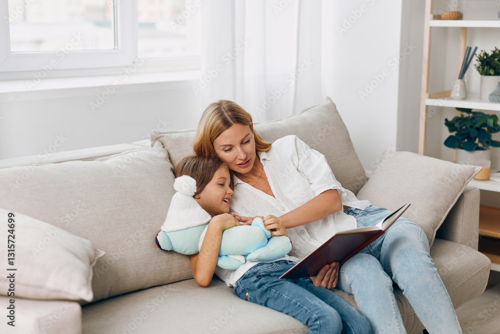 Mother and child bonding on the couch as they immerse themselves in a captivating storybook adventure Mother and child bonding on the couch as they immerse themselves in a captivating storybook adventure