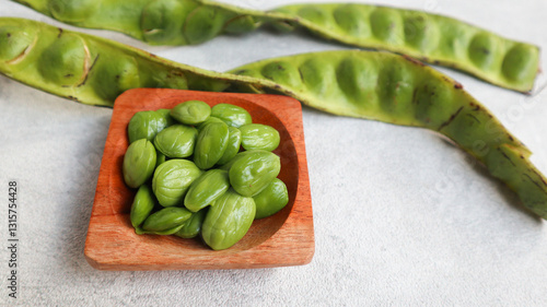Принти на полотні Raw Pete or Petai ,Popular Stinky Bitter Bean on wooden bowl isolated on grey