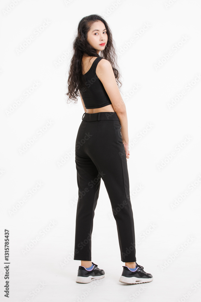 Portrait of full body asian beautiful woman with curly hair, wearing black tank top black long pants, model girl attractive confident standing smiling pose look at camera on white background in studio Portrait of full body asian beautiful woman with curly hair, wearing black tank top black long pants, model girl attractive confident standing smiling pose look at camera on white background in studio
