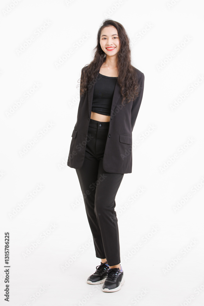Portrait full body of asian beautiful woman curly long hair, wearing black suit, black long pants, model girl attractive confident charming, standing pose look at camera on white background in studio. Portrait full body of asian beautiful woman curly long hair, wearing black suit, black long pants, model girl attractive confident charming, standing pose look at camera on white background in studio.