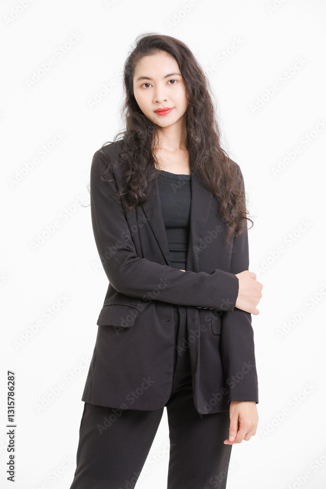 Portrait of asian beautiful woman curly long hair, wearing black suit, black long pants, model girl positive attractive confident charming, standing pose look at camera on white background in studio. Portrait of asian beautiful woman curly long hair, wearing black suit, black long pants, model girl positive attractive confident charming, standing pose look at camera on white background in studio.