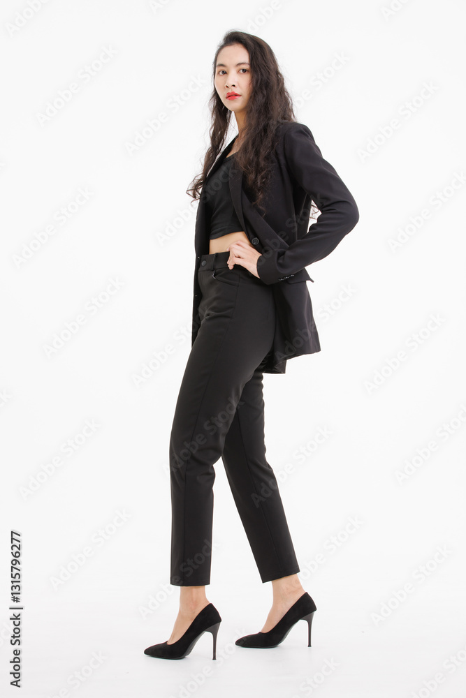 Portrait full body of asian beautiful woman curly long hair, wearing black suit, black long pants, model girl attractive confident charming, standing pose look at camera on white background in studio. Portrait full body of asian beautiful woman curly long hair, wearing black suit, black long pants, model girl attractive confident charming, standing pose look at camera on white background in studio.