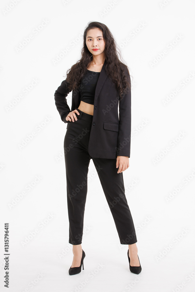 Portrait full body of asian beautiful woman curly long hair, wearing black suit, black long pants, model girl attractive confident charming, standing pose look at camera on white background in studio. Portrait full body of asian beautiful woman curly long hair, wearing black suit, black long pants, model girl attractive confident charming, standing pose look at camera on white background in studio.