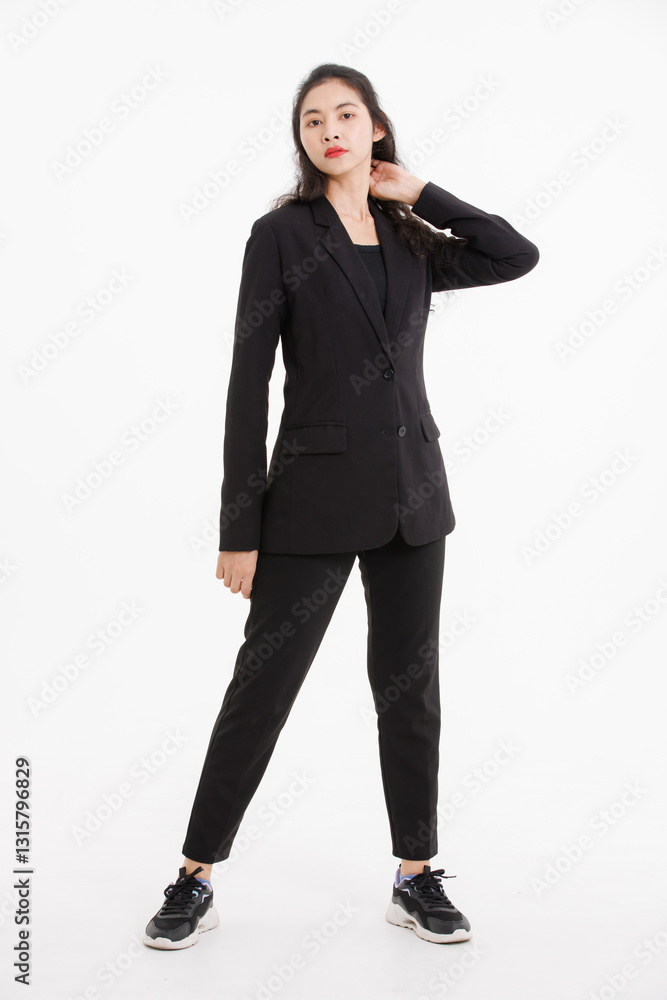 Portrait full body of asian beautiful woman curly long hair, wearing black suit, black long pants, model girl attractive confident charming, standing pose look at camera on white background in studio. Portrait full body of asian beautiful woman curly long hair, wearing black suit, black long pants, model girl attractive confident charming, standing pose look at camera on white background in studio.