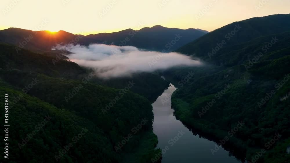 A breathtaking 4K aerial drone shot of a misty mountain valley during sunrise. The golden light touches the peaks, clouds gently roll over the hills, and a serene river winds through the valley. The s A breathtaking 4K aerial drone shot of a misty mountain valley during sunrise. The golden light touches the peaks, clouds gently roll over the hills, and a serene river winds through the valley. The s