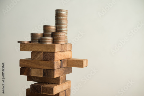 Canvas Print Stack coins on danger wood tower block game with white wall background copy space