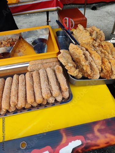 Vendor selling cuisine at street bazaar in Malaysia catered for iftar during Muslim fasting month of Ramadan