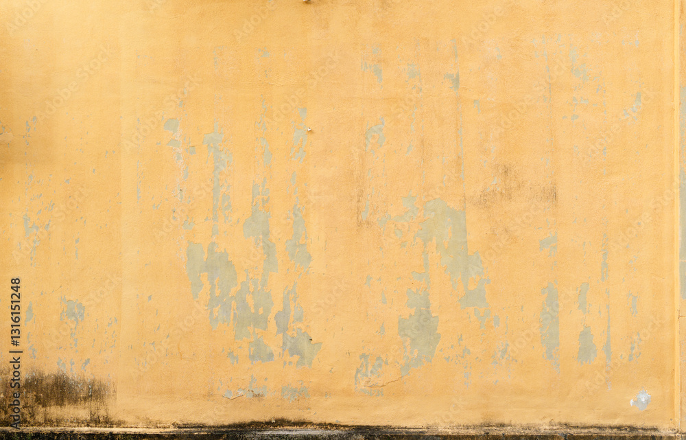 Fototapeta premium Textured Yellow Wall with Peeling Paint, Aged Building Facade