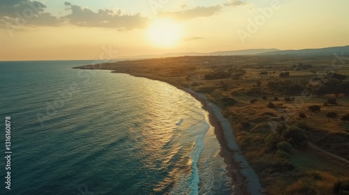 Breathtaking sunset over serene coastal landscape with tranquil waves and golden horizon