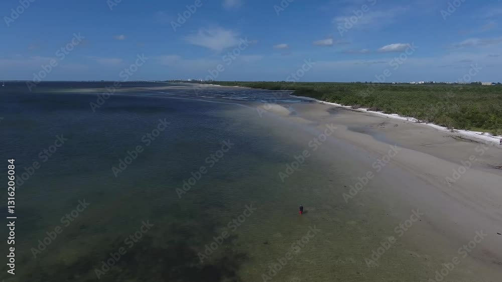A kayaker in the shallow waters off the coast of Florida. A kayaker in the shallow waters off the coast of Florida.