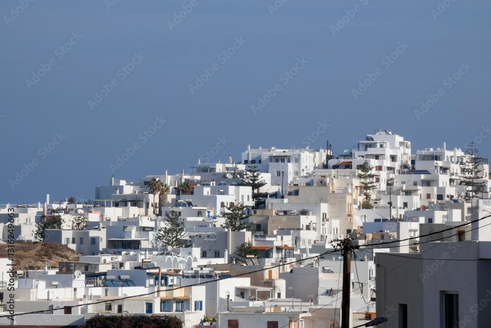 Whitewashed church and houses overlooking sparkling aegean sea in santorini, greece Whitewashed church and houses overlooking sparkling aegean sea in santorini, greece