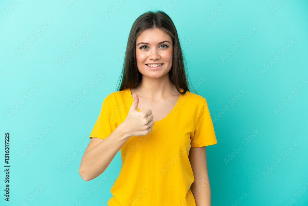 Young caucasian woman isolated on blue background giving a thumbs up gesture Young caucasian woman isolated on blue background giving a thumbs up gesture