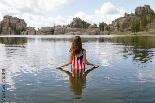 Woman in American flag swimsuit standing in Sylvan Lake photo