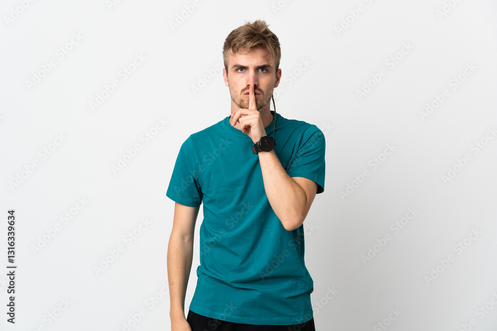 Obraz premium Young handsome man isolated on white background showing a sign of silence gesture putting finger in mouth