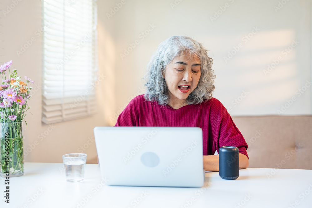 Contemporary retired woman using voice commands to control smart speaker, mature woman talking to the digital virtual assistant at home, asking a question or requesting to switch music. Contemporary retired woman using voice commands to control smart speaker, mature woman talking to the digital virtual assistant at home, asking a question or requesting to switch music.
