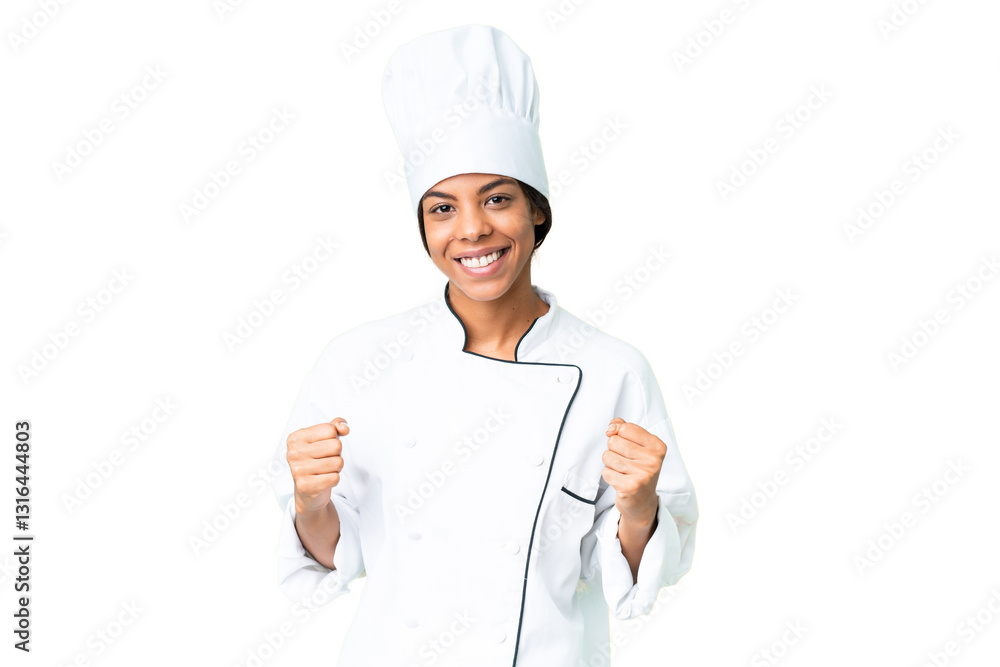 Young African American chef over isolated chroma key background celebrating a victory in winner position Young African American chef over isolated chroma key background celebrating a victory in winner position