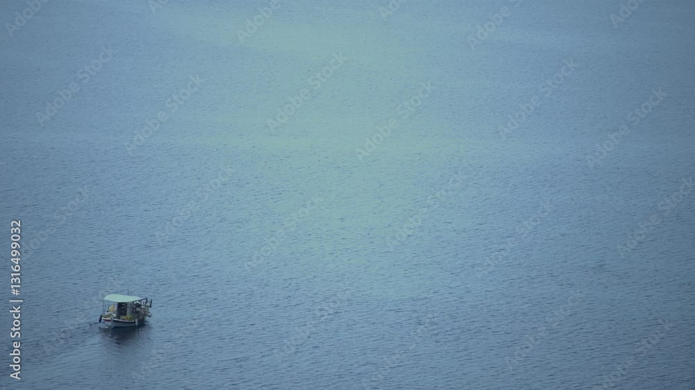 Small fishing boat at deep blue calm sea Small fishing boat at deep blue calm sea
